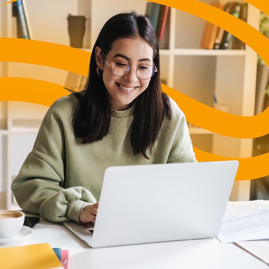 Woman Smiling Working on Laptop