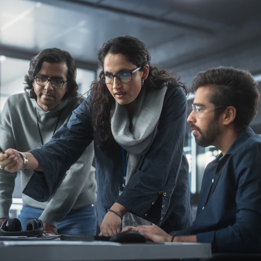 Coworkers Looking at a Computer and Figuring Out a Problem