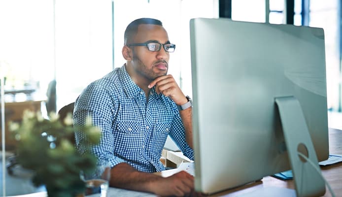 Pensive Man Looking at a Computer