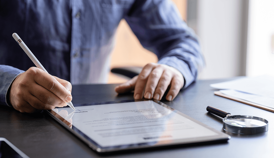 Person Writing on a Tablet Device