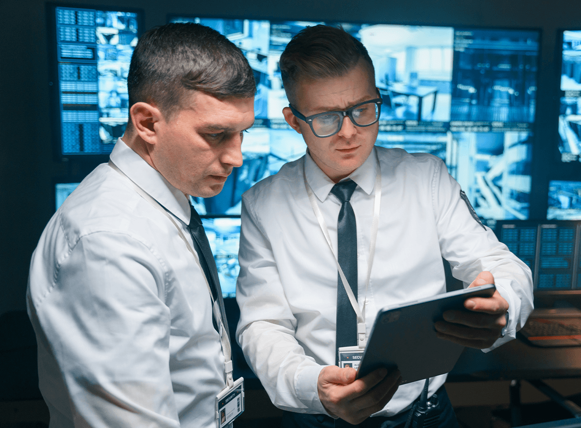 Two people reading a policy on a tablet