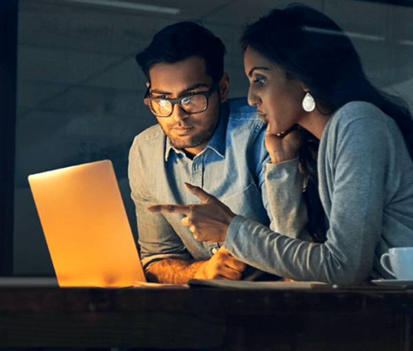 Two people looking at a computer