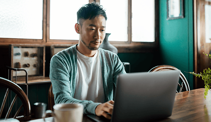 Man Reading Information on His Laptop