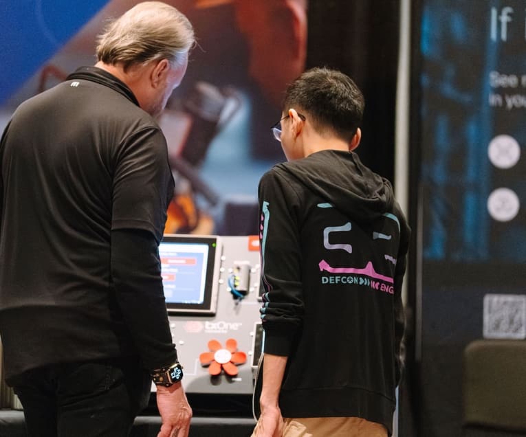 SANS ICS Security Summit 2026: Two People Collaborating On a Project