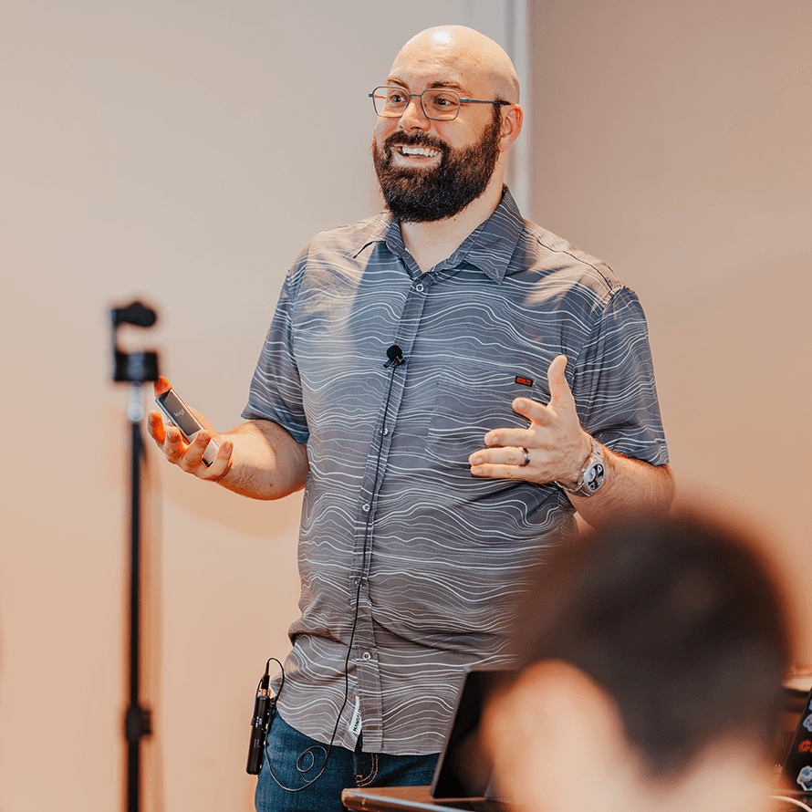Teacher Smiling and Explaining a Concept