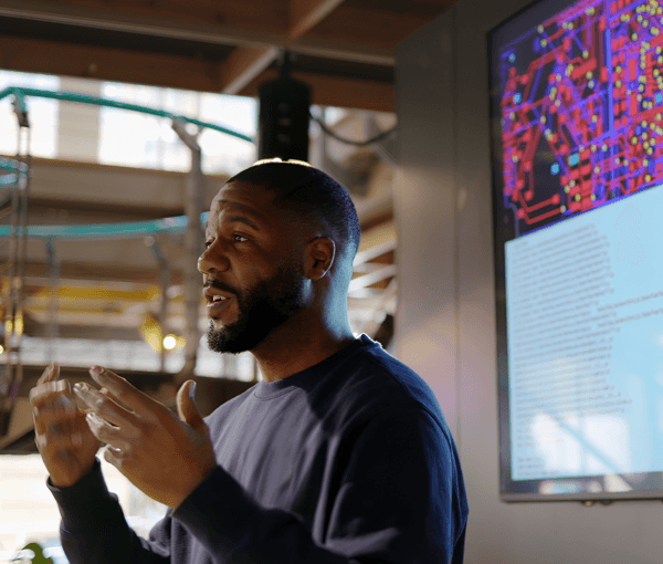 Man lecturing in front of board