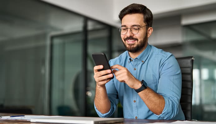 Smiling Man Scrolling On His Phone