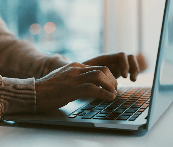 Hands Typing on Keyboard