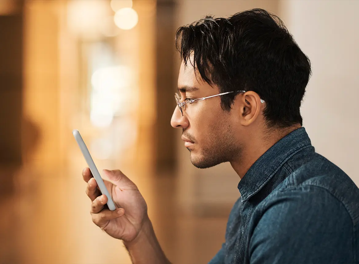 Man Reading Content on Phone