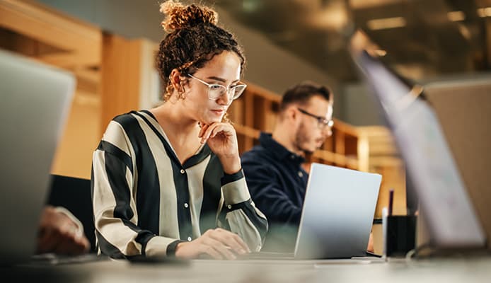 A Serious Woman Reading Content From Laptop