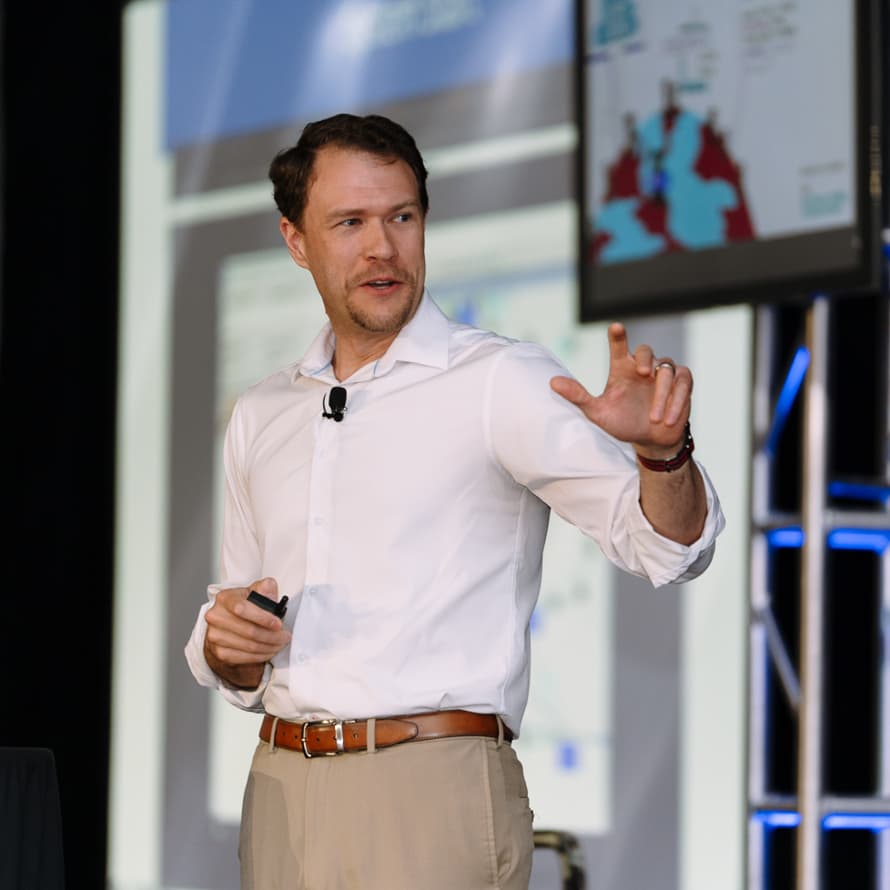 Man presenting at a Summit