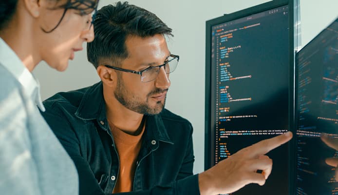 Close Up of Two People Looking at Code
