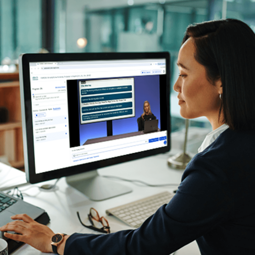 Woman Participating in Ondemand Training with Monitor Showing Training